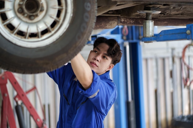 Auto car repair service center Mechanic examining car suspension