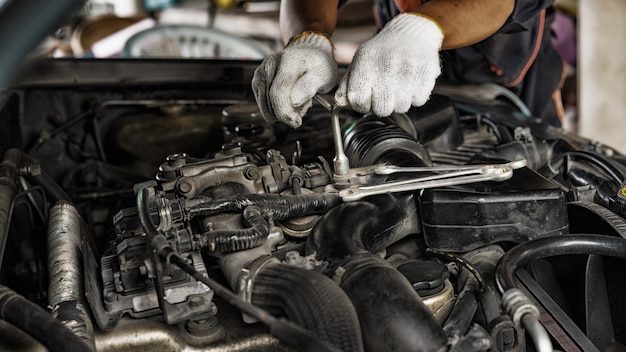 Auto mechanic Preparing For the work. Mechanic with Stainless Steel Wrench in Hand.