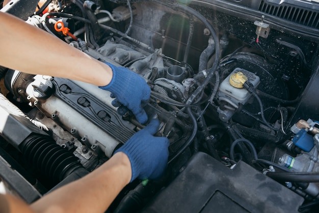 An auto mechanic repairing a car engine