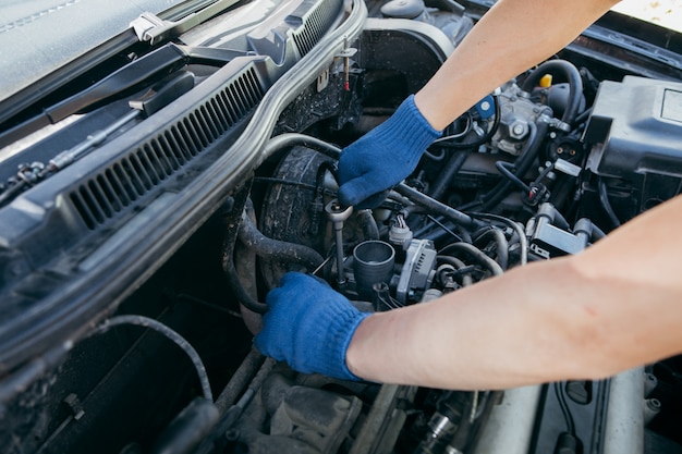 An auto mechanic repairing a car engine