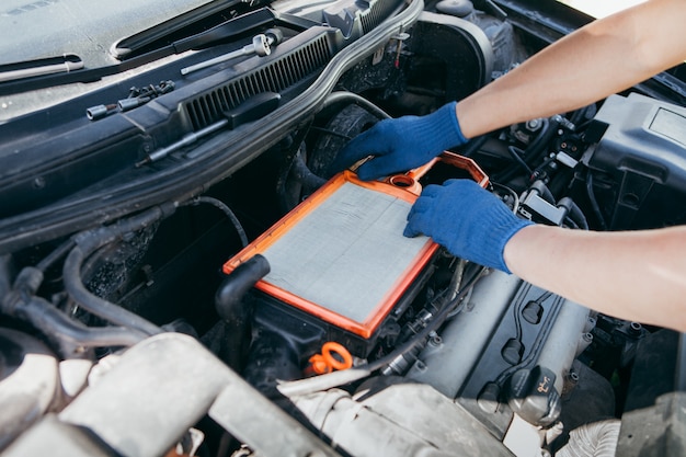 An auto mechanic repairing a car engine