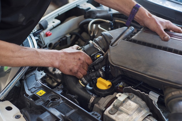 Auto mechanic repairing car. Selective focus.