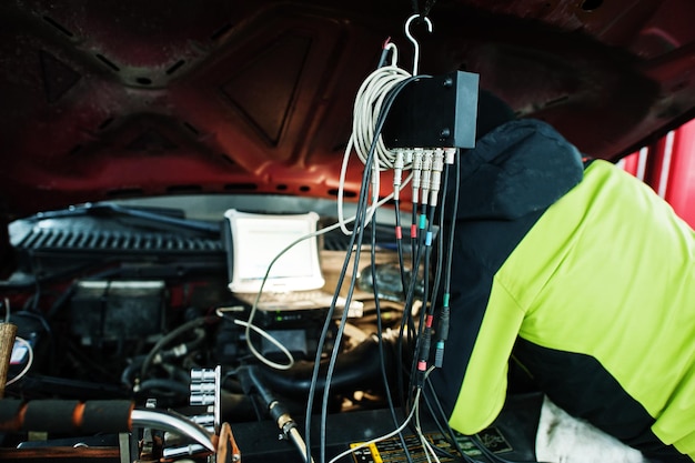 Auto mechanic sets american SUV car for diagnostics and configuration in workshop service station