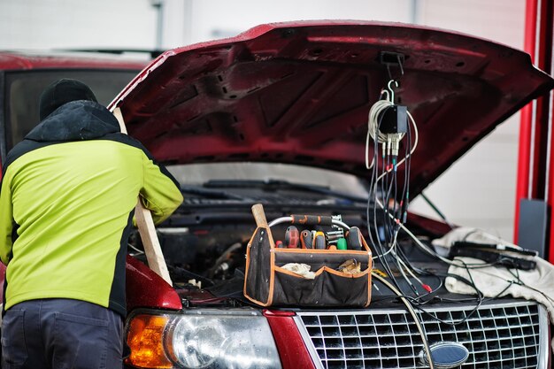 Auto mechanic sets american SUV car for diagnostics and configuration in workshop service station