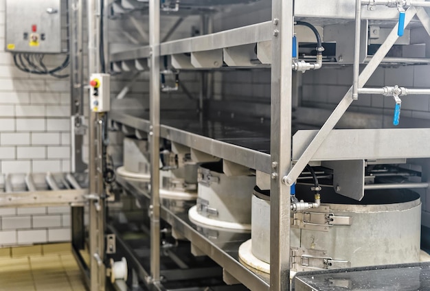 Automated equipment for the production of Gruyere de Comte Cheese in Franche Comte creamery, Burgundy, in France.