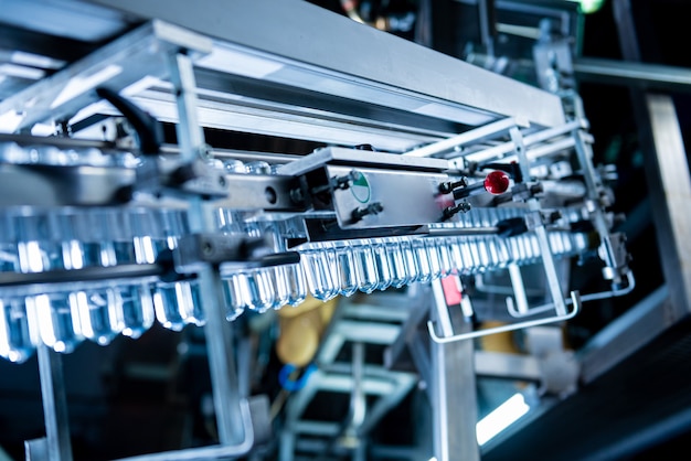 Automatic filling machine pours water into plastic pet bottles at modern beverage plant