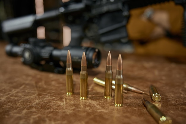 Photo automatic rifle and bullets at weapon store