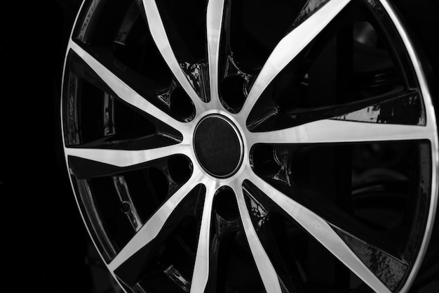 Automotive alloy wheel closeup on a black background showcase template