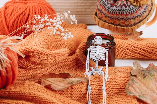 Autumn background Cozy warmth halloween Sweater and skeleton Happy Halloween