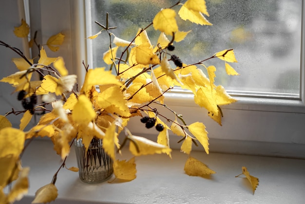 Autumn bouquet of birch branches with yellow leaves