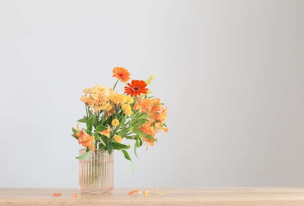 autumn bouquet on wooden shelf on background gray wall