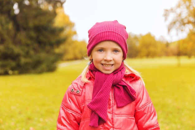 autumn, childhood, happiness and people concept - happy beautiful little girl portrait outdoors