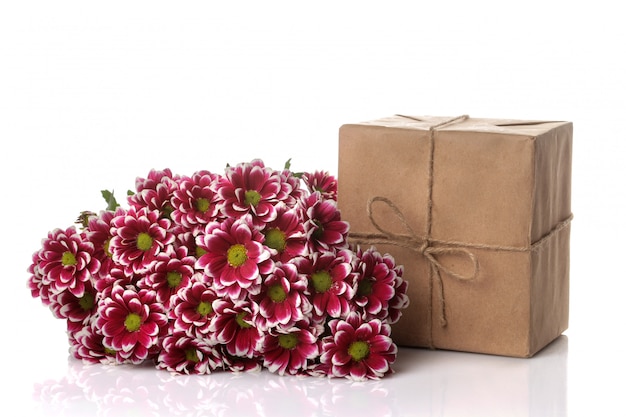 Autumn chrysanthemum flowers and gifts in kraft paper on white isolated