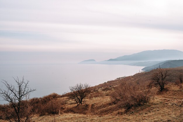 Autumn coast with blue sea and rocky land