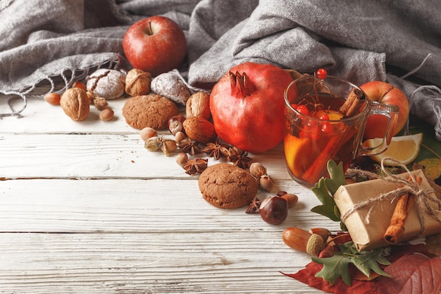 Autumn composition of autumn leaves fruits and spices on a white wooden table