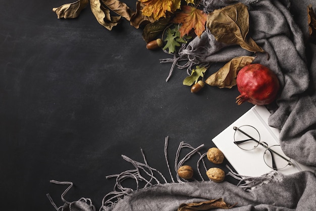 Autumn composition of dry leaves and fruits on a dark background Top view Copy space