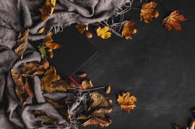 Autumn composition of dry leaves and fruits on a dark background Top view Copy space