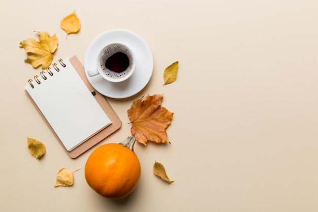 Autumn composition fallen leaves and notebook mock up on colored background Top view Flat lay with copy space