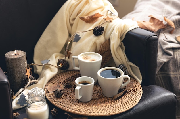 Autumn composition with cups of coffee and leaves