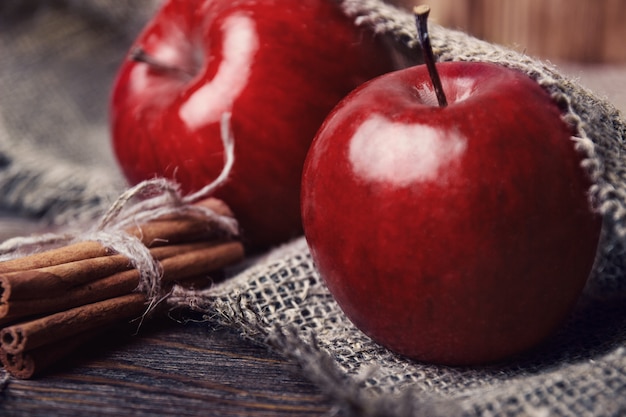 Autumn composition with fresh red apples on table