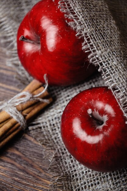 Autumn composition with fresh red apples on table