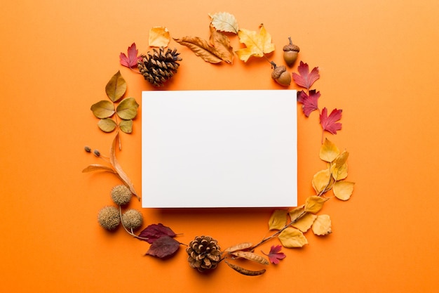 Autumn composition with paper blank and dried leaves on table Flat lay top view copy space