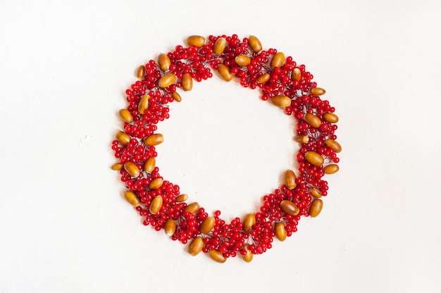 Autumn composition with red berry. Wreath made of viburnum berries