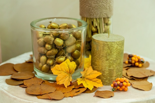 Autumn decoration of nuts from yellow leaves and candles. Autumn decoration for interior handmade