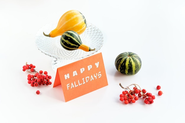 Autumn decorations card with text Happy Fallidays Natural decorative Fall pumpkins rowan berry