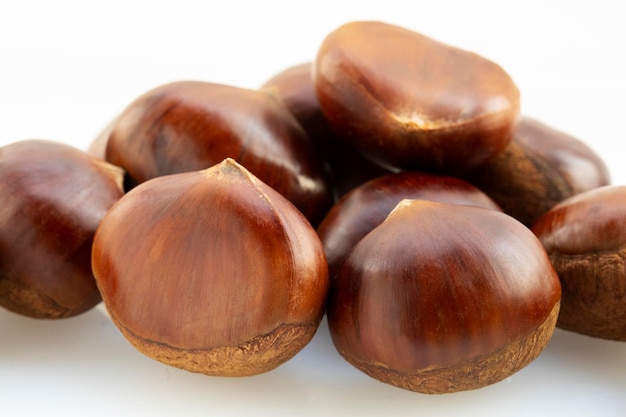 Autumn delicacies, chestnuts in front of white background