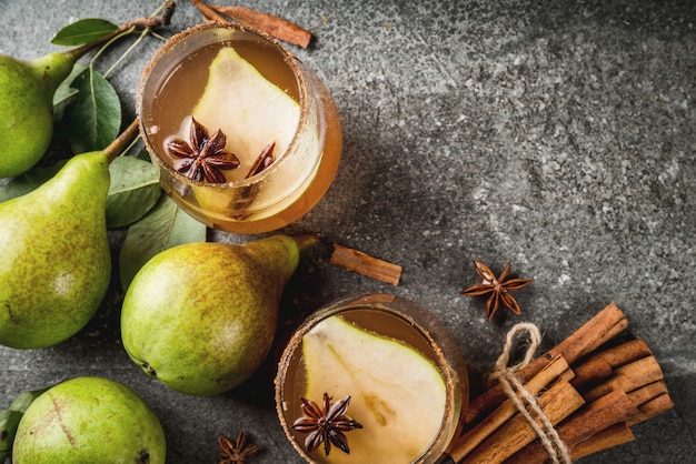 Autumn drinks. Mulled wine. Traditional autumn spicy cocktail with pear, cider and chocolate syrup