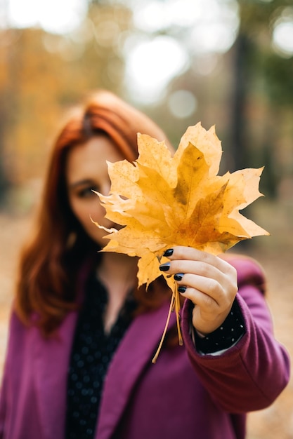 Autumn fashion earth tones style bright fall color palette portrait of redhaired girl in purple coat