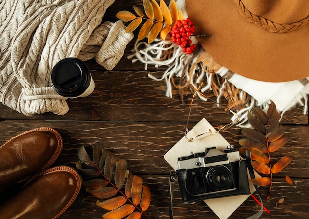 Autumn flat lay, hat, sweater, camera, coffee. cozy autumn