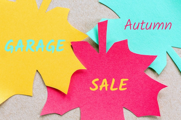 Autumn garage sale announcement on paper leaves background