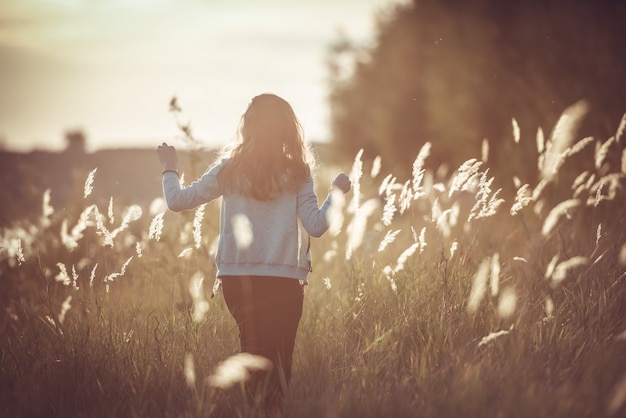 Autumn Girl enjoying nature on the field. 