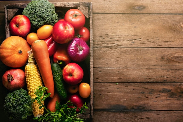 Autumn harvest a wooden container with fresh vegetables on a rustic table copyspace copy space