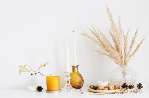 Autumn home decorations with burning candles