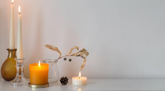 autumn home decorations with burning candles