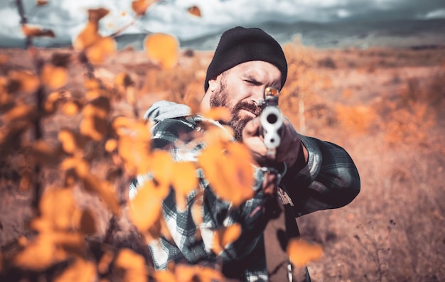 Autumn hunting season Close up snipers carbine at the outdoor hunting Hunter with shotgun gun on hunt Hunting without borders Poacher in the Forest