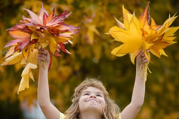 Autumn kids mood child with fall leaves over maple leaf background