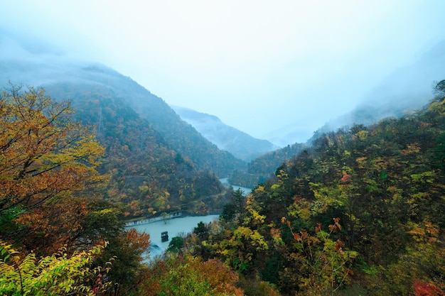 Autumn landscape in the mountain lake and fog in the storm at morning time in japan