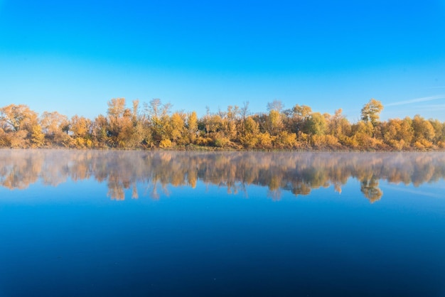 Autumn landscape river in the morning fog over the water panorama of the river in autumn