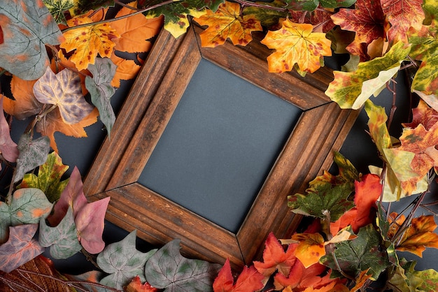 Autumn leaves are red and orange composition with picture frame copy space flat lay