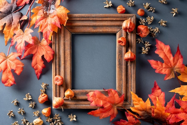 Autumn leaves are red and orange composition with picture frame copy space flat lay