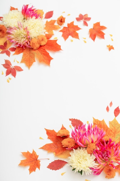 Autumn leaves and flowers composition on white background