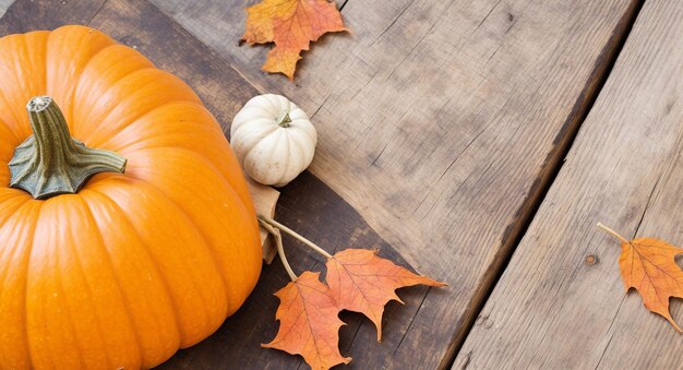 Autumn Leaves And Pumpkin Arrangement On Wooden Table