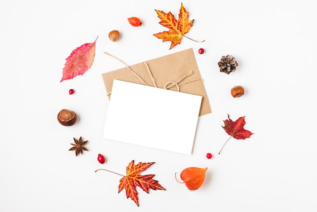 Autumn leaves with nuts and envelope