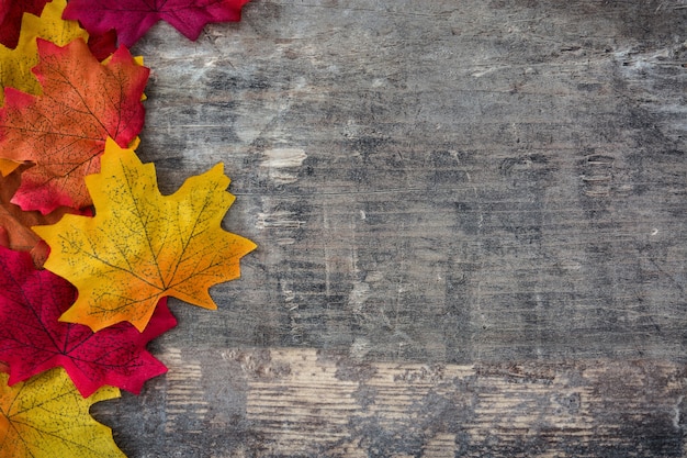 Autumn leaves on wooden background