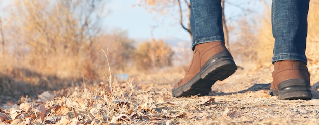 In autumn a man walks on leaves