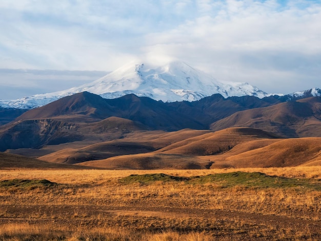 Autumn mountain plateau picturesque morning sunny view View of the snowy Elbrus volcano in autumn Russia the Caucasus